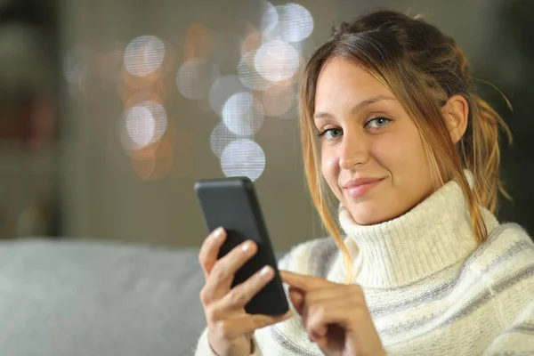 Confident woman using mobile phone looks at camera — 스톡 사진