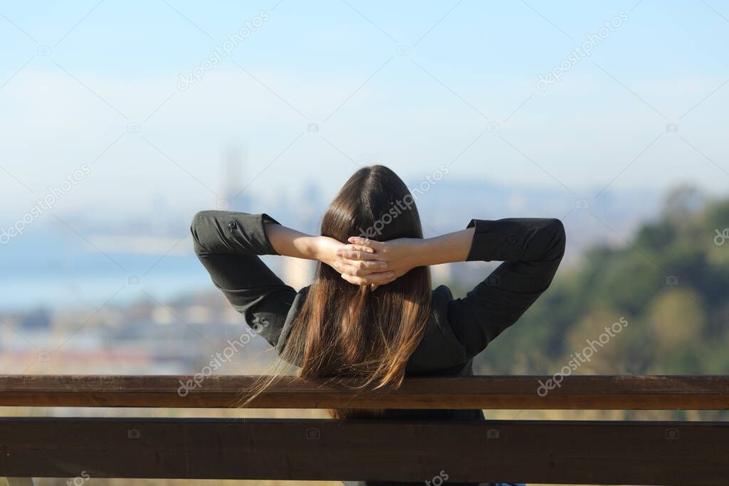 Businesswoman relaxing resting sitting on a bench