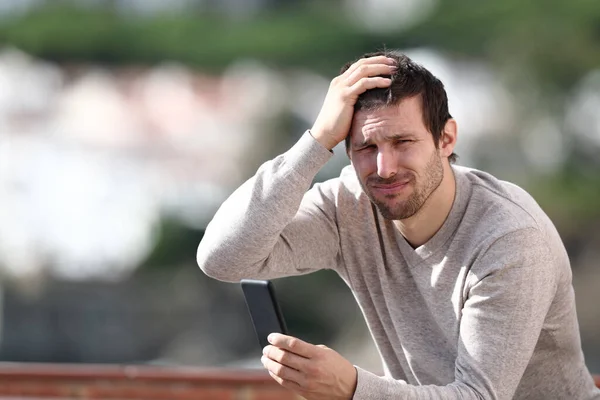 Confused Man Holding Mobile Phone Complaining Mistake Sitting Rural Town — Stock Photo, Image