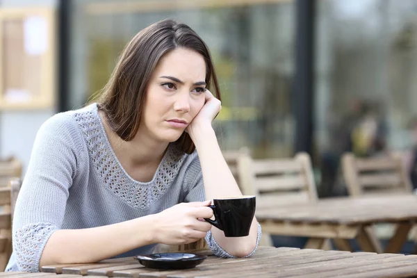 Sad Young Woman Looking Away Holding Cup Coffee Restaurant Terrace — Stok fotoğraf