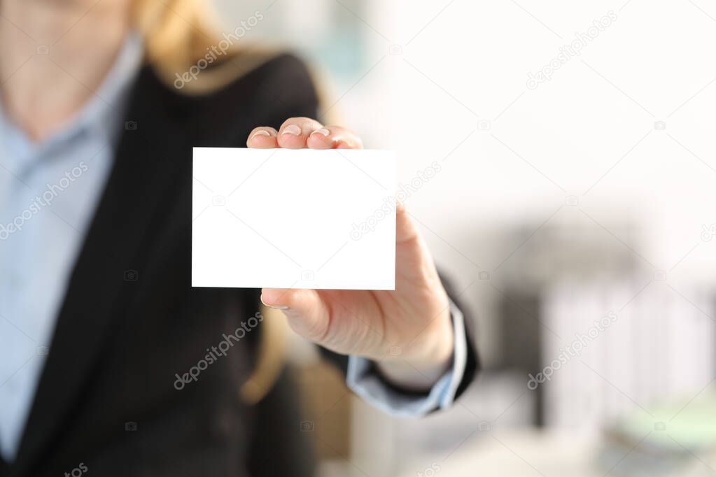 Close up of executive woman hand showing blank business card to camera in the office