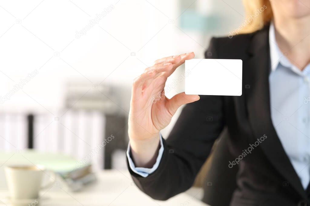 Close up of business woman hand showing blank credit card at the office