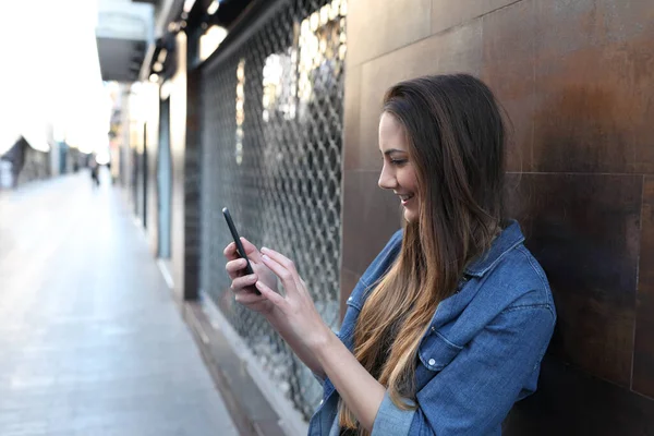 Mutlu Bir Kızın Yan Görünüş Portresi Sokakta Akıllı Telefonu Kontrol — Stok fotoğraf