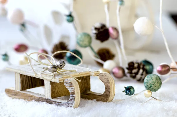Wooden sled with snow, Christmas garland and cart — Stock Photo, Image