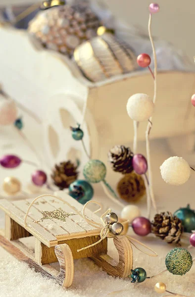 Vintage wooden sled, Christmas garland and cart with bronze glass baubles — Stock Photo, Image