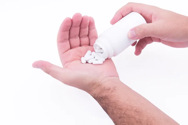 Holding pills in hand — Stock Photo, Image