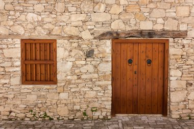 Ancient door and windows on a stone wall clipart