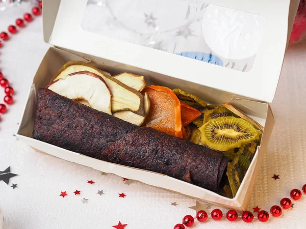 Fruit leather and dried fruits in the present box