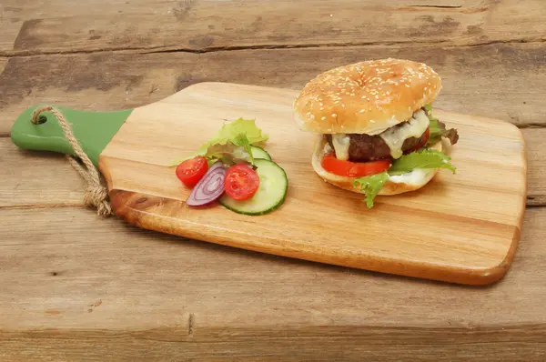 Cheeseburger on a board — Stock Photo, Image
