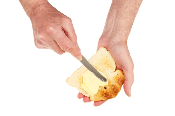 Hands buttering toast — Stock Photo, Image