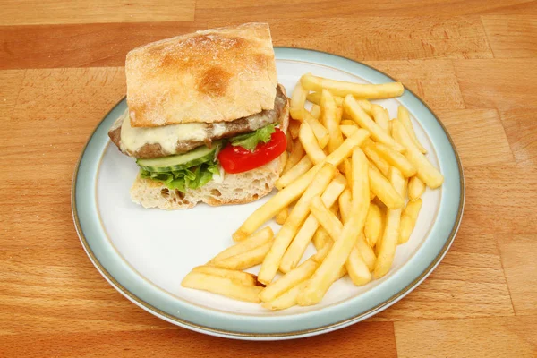 Burger and fries on a table — Stock Photo, Image