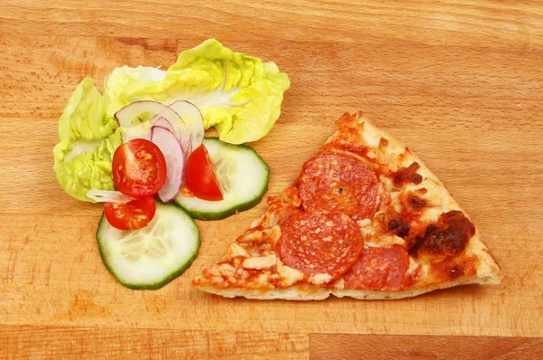 Slice of pizza and salad