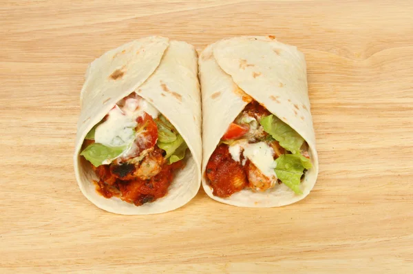 Two fajita wraps on a board — Stock Photo, Image