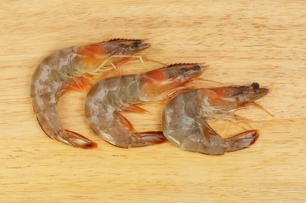 Tiger prawns on a board — Stock Photo, Image