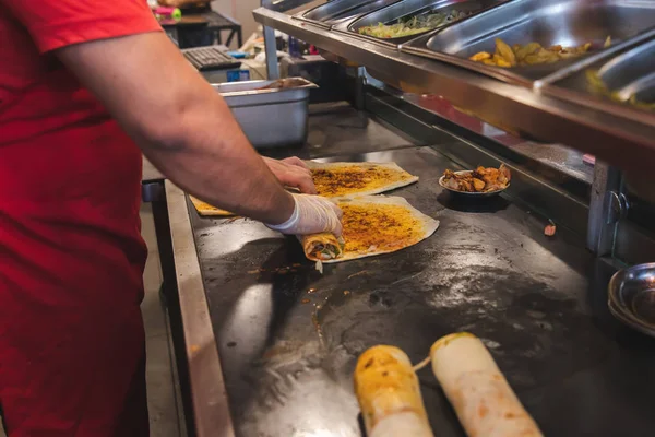 Chef preparing and making Traditional Turkish Doner Kebab meat. Shawarma or gyros. Turkish, greek or middle eastern arab style chicken doner kebab food on isolated white.