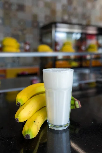 Banana juice smoothie milk shake with some ingredients. Blender with full of milk, banana and honey. Smoothies maker. Milk shaker