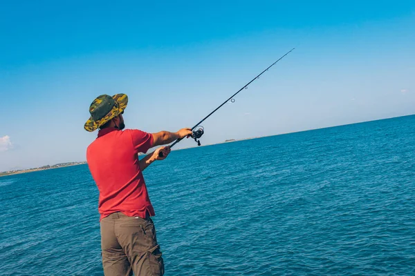 Pescador Pie Lanzar Una Caña Pescar Mientras Pesca Mar Temporada —  Fotos de Stock
