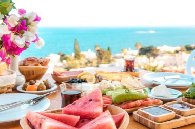 Oteldeki kumsalda kahvaltı ya da yaz mevsiminde deniz kenarında tatil. Tatil ve tatil kahvaltısı görüntüsü. Türkiye veya Yunanistan 'ın Bodrum kentinde geleneksel Türk veya Yunan kahvaltısı