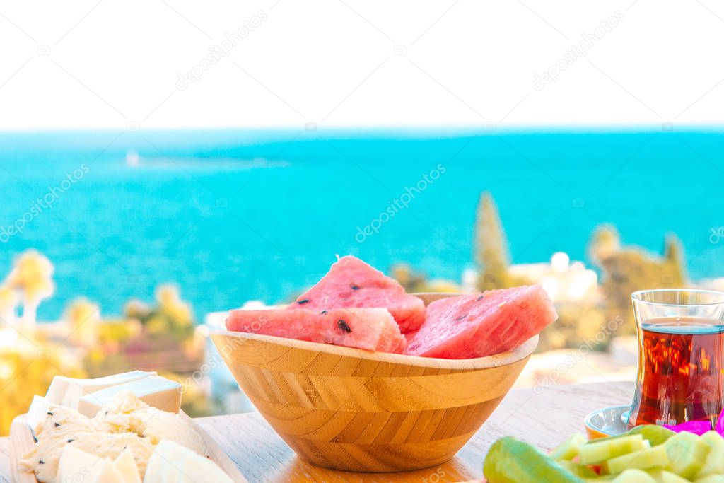 Breakfast on the beach at hotel or resort by the sea in summer season. Holiday and vacation breakfast image.Traditional Turkish or Greek breakfast at bodrum town beach in Turkey or Greece