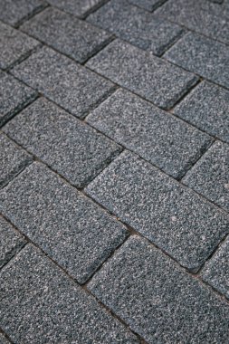 Gri tuğla döşemeli sokak kaldırımı desenli arka plan.