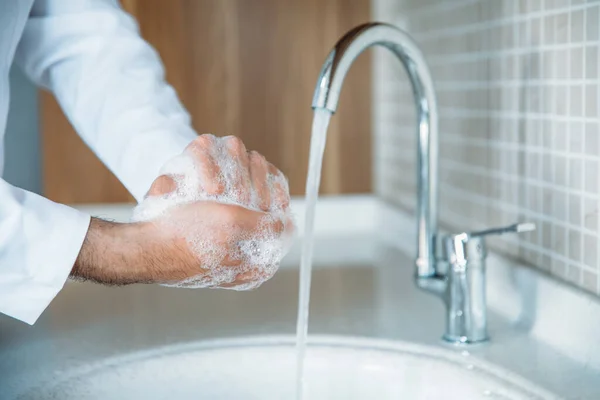 Man washing hands properly with soap to be protected for Coronavirus 2019-nCoV pandemic epidemic infection. Doctor shows how to wash hands properly.