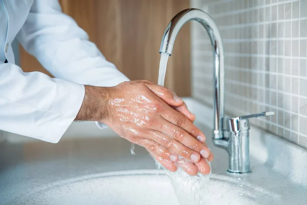 Man washing hands properly with soap to be protected for Coronavirus 2019-nCoV pandemic epidemic infection. Doctor shows how to wash hands properly.