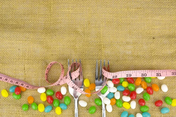 Colorful candies fork and tape measure with shallow depth of field (dof — Stock Photo, Image