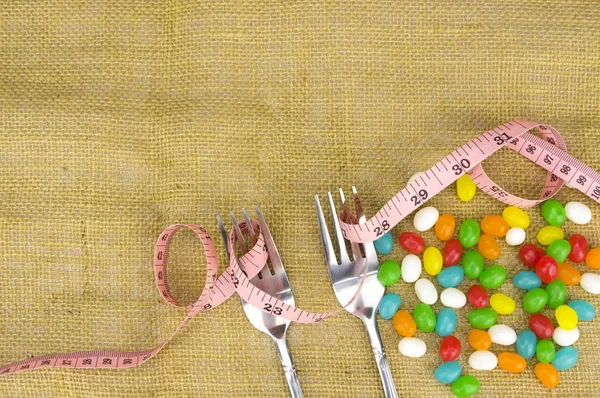 Colorful candies fork and tape measure with shallow depth of field (dof — Stock Photo, Image