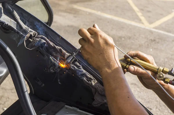 Close up work with welding equipment - welding car body. — Stock Photo, Image