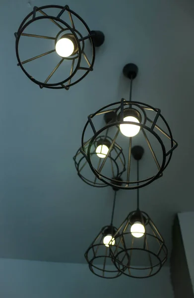 Vintage hanging light bulb over grey room