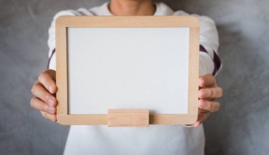 Boş bir beyaz tahta tutan kadın