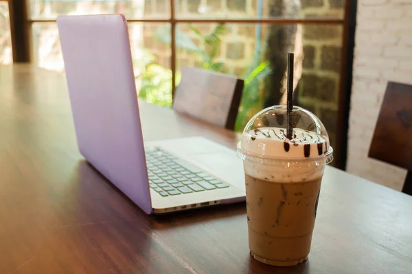 Ноутбук на деревянном столе в кафе — стоковое фото