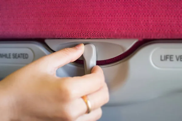 Hand On Hidden Table Of Airplane Seat — Stock Photo, Image