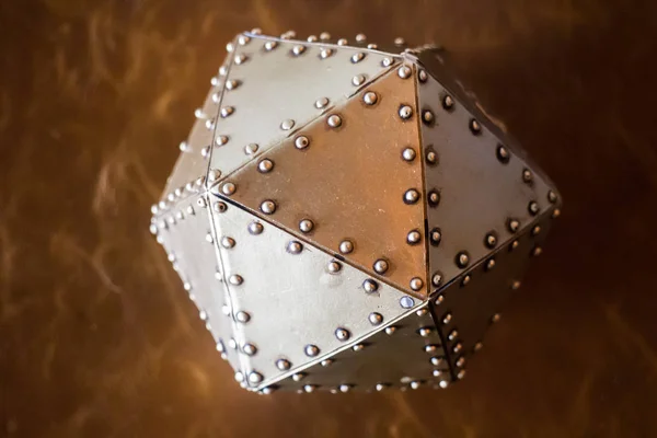 Metal hexagon ball on brown leather background — Stock Photo, Image