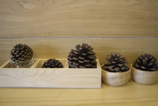 Brown pine cones on wooden table — Stock Photo, Image