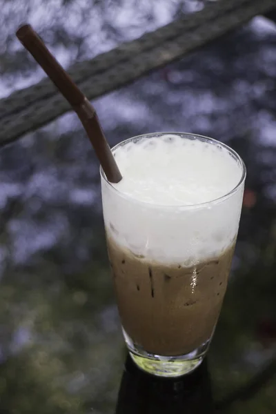 Milk foam top on chocolate iced glass — Stock Photo, Image