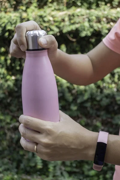 Main sur la bouteille d'eau pour garder la température — Photo