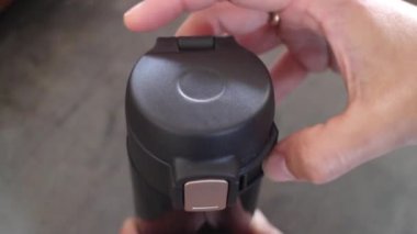 Hand opened eco-friendly reusable thermo bottle, stock footage