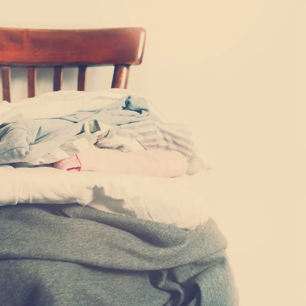 Vintage Chair Pile Clothes White Wall Toned — Stock Photo, Image