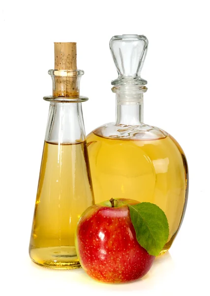 Apple cider vinegar in a glass vessel and red apple — Stock Photo, Image