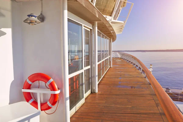 Wooden deck, life ring and seascape