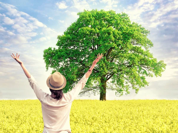 Woman enjoying summer time in yellow field — Stock Photo, Image