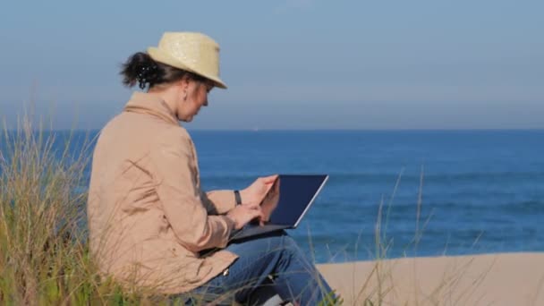 Freelancer woman working in her notebook on beach — Stock Video