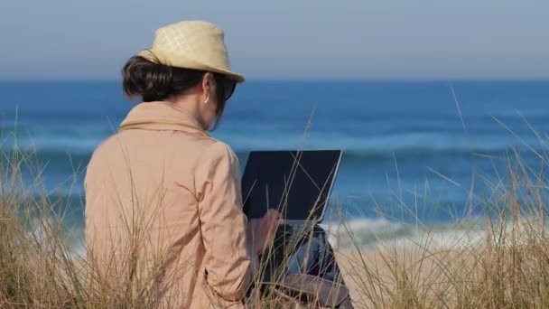 해변에 있는 공책에서 일하는 블로거 — 비디오