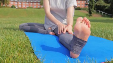 Genç bir kadın doğada yoga egzersizi yapıyor.