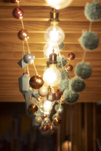 Bright blurry garlands of retro lamps and paper figures