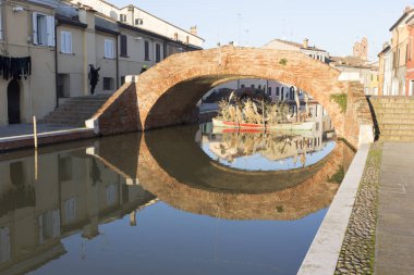 Comacchio, İtalya - 28 Aralık 2019: Güneşli bir kış gününde Comacchio caddesinde yürüyen çok az kişi var