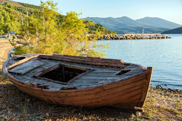 Abandoned wooden boat at a sea shore near Mt Pelion in Thessaly, Greece