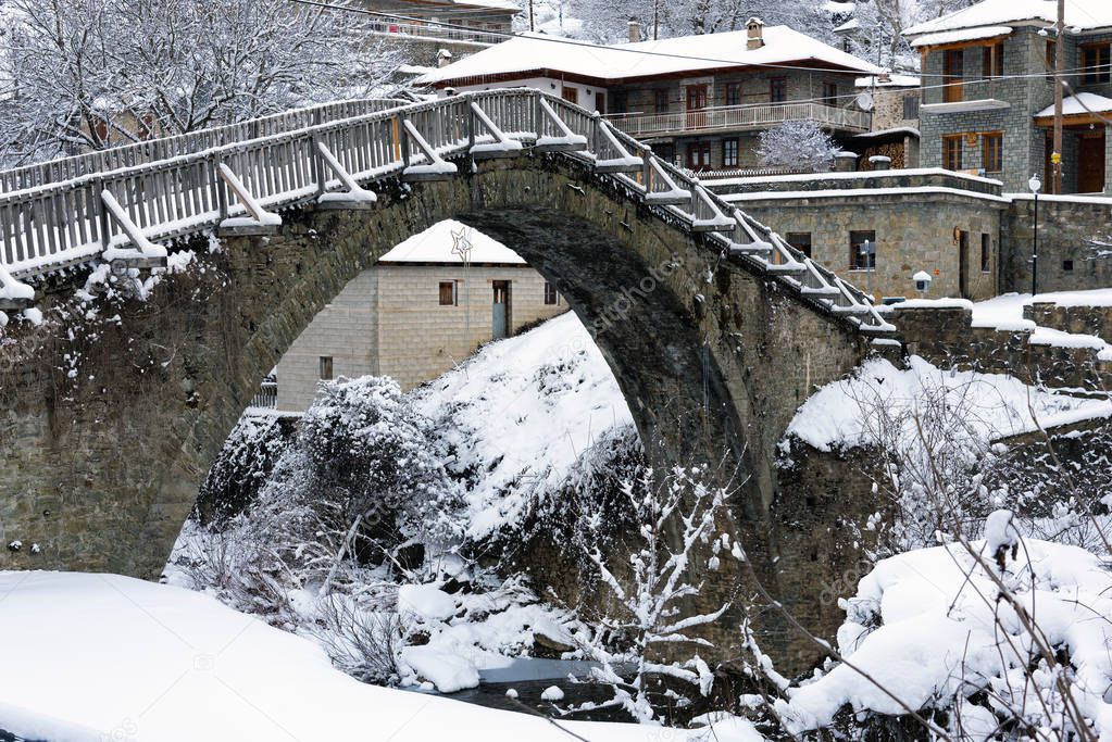 View of the traditional stone bridge in Vovousa village in Epirus, Greece in winter