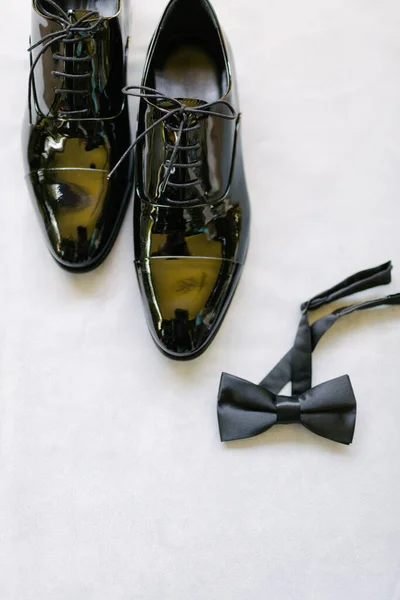 Groom shoes and bow tie. Preparations for the wedding day.